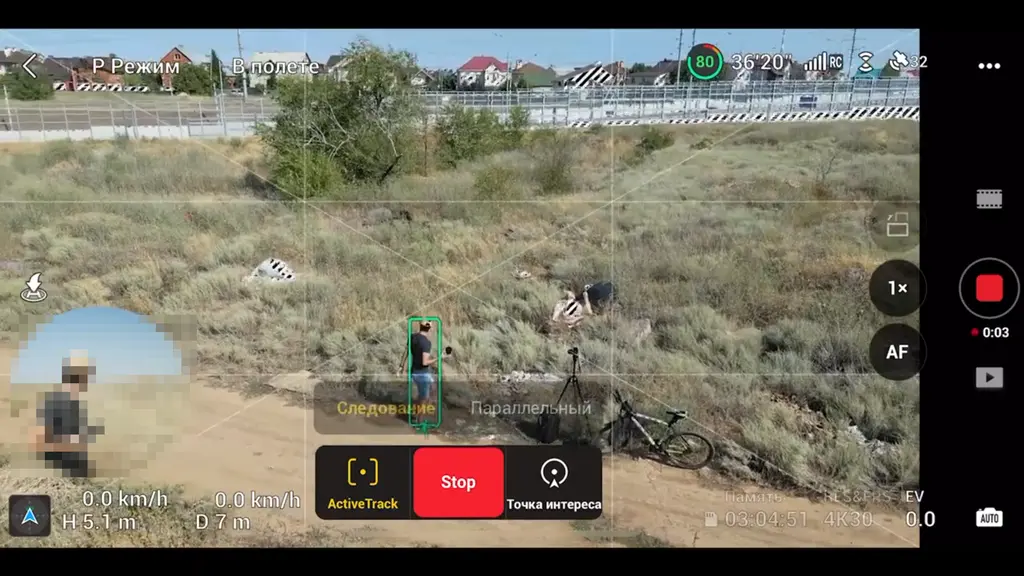 Экран пульта с записью видео на дроне над пустырём