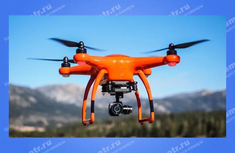 Оранжевый квадрокоптер Autel Robotics X-Star Premium на фоне гор